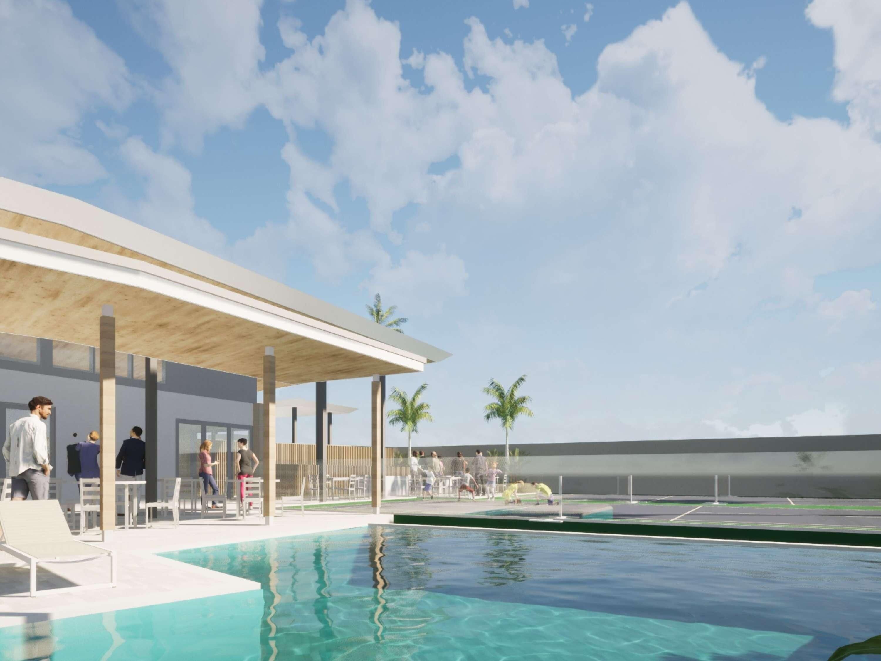 A modern outdoor pool area with a covered seating area and a clear sky.