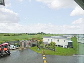 A rural setting with a white building, a tractor, and a deer statue. - 3 bedroom accommodation in Anderby Creek (Anderby Creek)