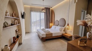 Ein modernes Hotelzimmer mit einem großen Bett, einem Schreibtisch und einem Regal mit Dekorationen.