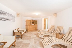 A spa room with wooden loungers, a wooden cabinet, and a tiled floor. - Chalet Tubbs (4 persons) (Mauterndorf)