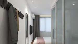 A modern hotel room with a bed, a TV, a wardrobe, and a sliding door. - Happy Dragon Alley Hotel-Forbidden City (Beijing)