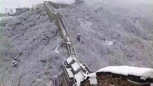 A snow-covered mountain with a long wall running along it. - Happy Dragon Alley Hotel-Forbidden City (Beijing)