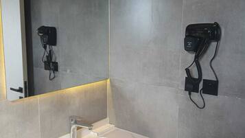 Deluxe Studio Suite, City View | Bathroom | Separate bathtub and shower, rainfall showerhead, free toiletries