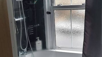 Combined shower/bathtub, deep-soaking bathtub, hair dryer, towels