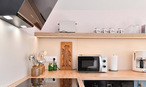 A modern kitchen with a microwave, toaster, and coffee maker. - Charming lodging, peaceful balcony-terrace (Wettolsheim)