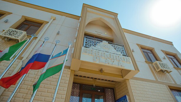 A building with a sign reading 'SHERIGIR PLAZA'. - Shergiron Plaza (Bukhara)