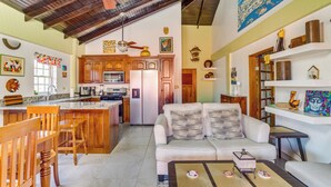 A spacious living area with a kitchen, a dining table, and a sofa. - Private 2BR 3RD Floor Villa-Shared Pool-Beach (North Placencia)