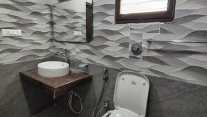A bathroom with a toilet, sink, mirror, and window. - S L Homestay (Tiruvannamalai)