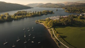 A river with boats, a marina, and a path along the riverbank. - Mereside Apartment Ridgestone (Windermere)