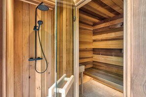 A wooden sauna with a glass door, a showerhead, and a bench. - Fawns Keep - Hot Tub Sauna Retreat Ridgestone (Windermere)