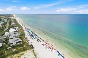 A coastal hotel with multiple buildings, a beach with umbrellas, and a clear view of the ocean. - Bluefish House • Six-Seater Golf Cart • Walk to Beach • Private Hot Tub (Santa Rosa Beach)