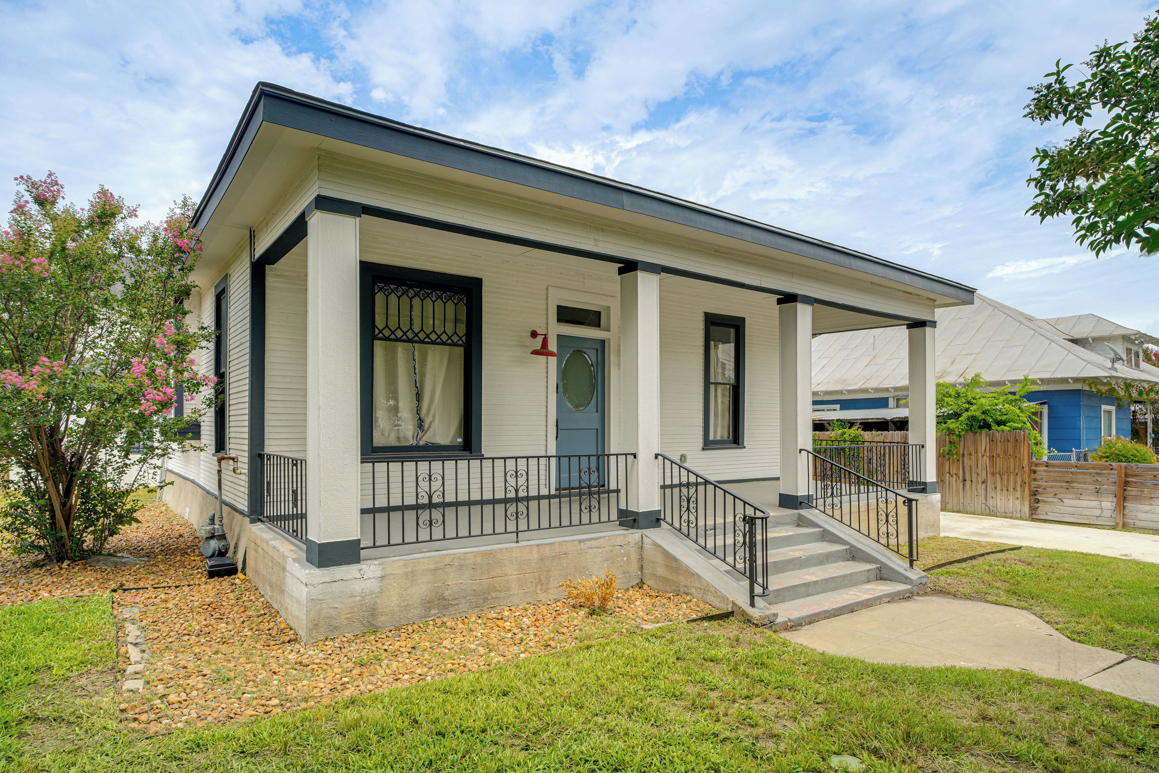 A single-story house with a front porch, a front door, and a small front yard.