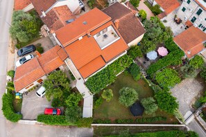 An aerial view of a residential area with multiple houses, a swimming pool, and a garden. - Pet friendly apartment Pergola in Poreč (Porec)