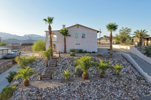 A house with a stone patio, palm trees, and a clear view of mountains in the background. - 2 Mi to River, Lake Mohave and Laughlin Casinos (Bullhead City)