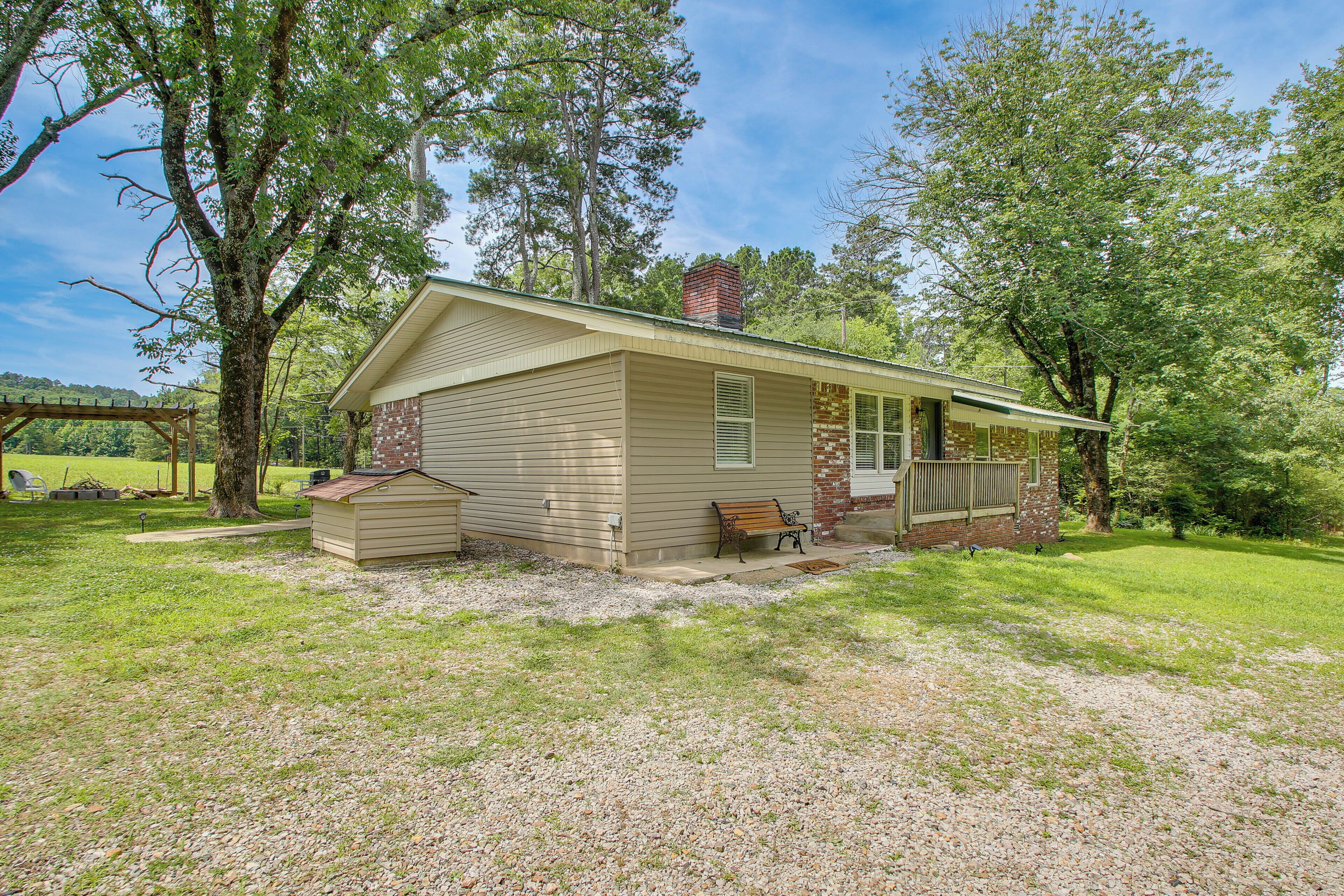 A single-story house with a front porch, a chimney, and a small deck.