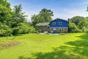 A house with a blue exterior, a front porch, and a well-maintained lawn. - 7 Mi to Stone Mtn Park! Spacious Family Getaway (Lilburn)