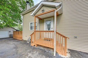 A house with a wooden porch, a garage, and a window.
