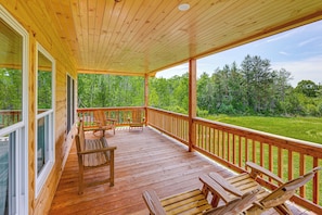 A wooden deck with a railing, benches, and a view of a forest. - Hike, Hunt & Golf! Cabin on 4 Acres in Naples (Naples)