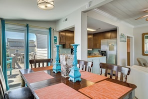 A dining area with a table, chairs, and decorative vases. - Red, White & Beach! 5BR Atlantic Beach Cottage (Atlantic Beach)