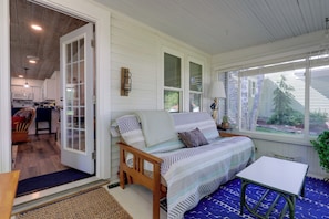 Una habitación acogedora con una cama, una mesita y vistas al exterior.
