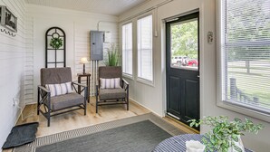 A room with two chairs, a lamp, a potted plant, and a door leading outside. - A Sisters Stay Farmhouse Retreat in Villa Ridge (Villa Ridge)