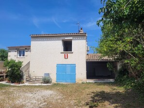 A two-story building with a blue door, a small window, and a chimney. - Sainte Marguerite by Interhome (Saint-Tropez)