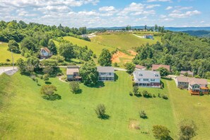 A residential area with houses on a hillside, surrounded by greenery and a clear sky. - Norris Lake House W Private Boat Slip & Game Room (LaFollette)