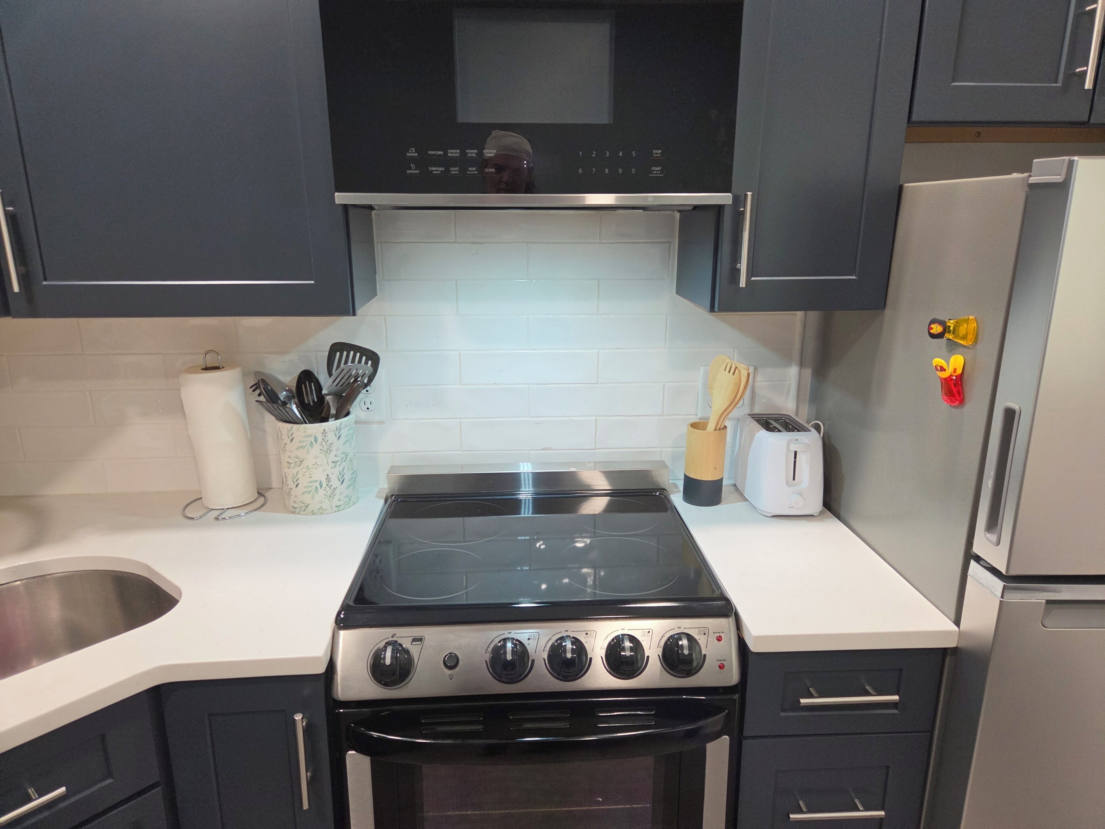A kitchen with a stove, oven, and a toaster on the counter.