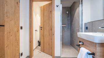 Suite, Partial Lake View | Bathroom | Shower, hair dryer, towels, soap