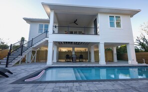 A two-story house with a balcony, a pool, and a staircase. - Coastal Retreat with Private Pool in Historic Saint Augustine Florida (St. Augustine)