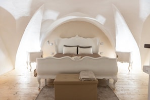 Ein Schlafzimmer mit einem großen Bett, Nachttischen und einer Bank.