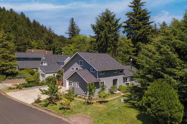Aerial view of the property nestled in a peaceful, tree-lined neighborhood, offering a private retreat surrounded by natural beauty and tranquil surroundings.