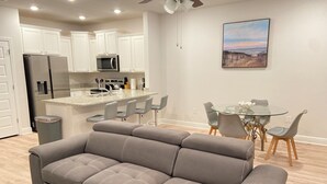 A modern kitchen with white cabinets, a built-in microwave, and a stainless steel refrigerator. - San Destin Dream Vacation 3-bedroom townhome in beautiful Santa Rosa Beach. (SANTA RSA BCH)