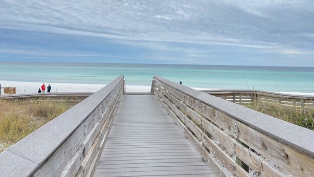 A wooden boardwalk leading to a beach with clear turquoise water and a cloudy sky. - San Destin Dream Vacation 3-bedroom townhome in beautiful Santa Rosa Beach. (SANTA RSA BCH)