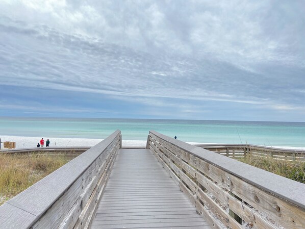 A wooden boardwalk leading to a beach with clear turquoise water and a cloudy sky. - San Destin Dream Vacation 3-bedroom townhome in beautiful Santa Rosa Beach. (SANTA RSA BCH)