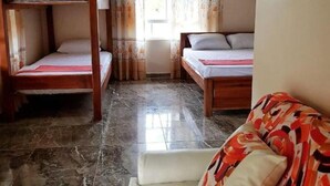 A room with a bunk bed, a sofa, and a window with curtains. - Cocoloco's Lodge - Family Bungalow (El Valle)
