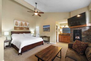 A bedroom with a bed, a ceiling fan, a nightstand, and a painting on the wall. - Comfortable Slope-Side Stroll Condo 658 (Mammoth Lakes)