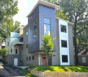 A modern multi-story residential building with a flat roof, large windows, and a small tree in the front yard. - Large Midtown near GA Tech home great for Corporate stays- 3 King Beds (Atlanta)