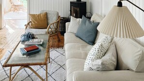 A cozy living room with a sofa, chairs, a glass coffee table, and a fireplace. - Personal style in a home between Vig and Høve (Vig)
