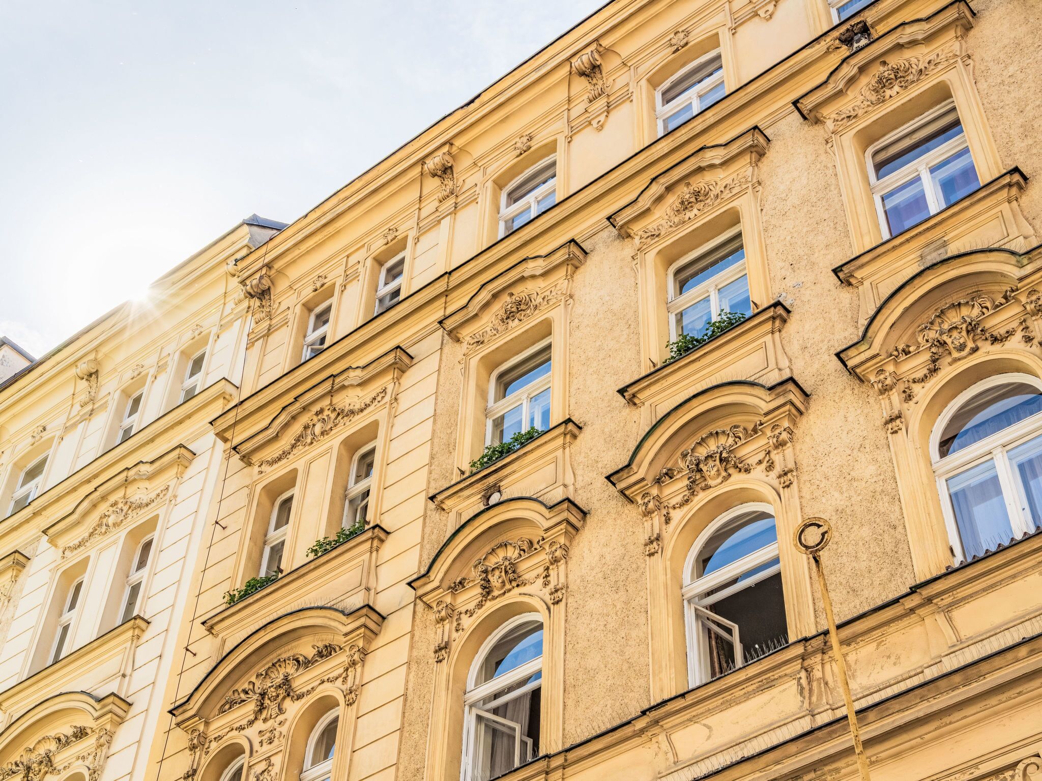 A multi-story building with ornate architectural details, including arched windows and decorative moldings.