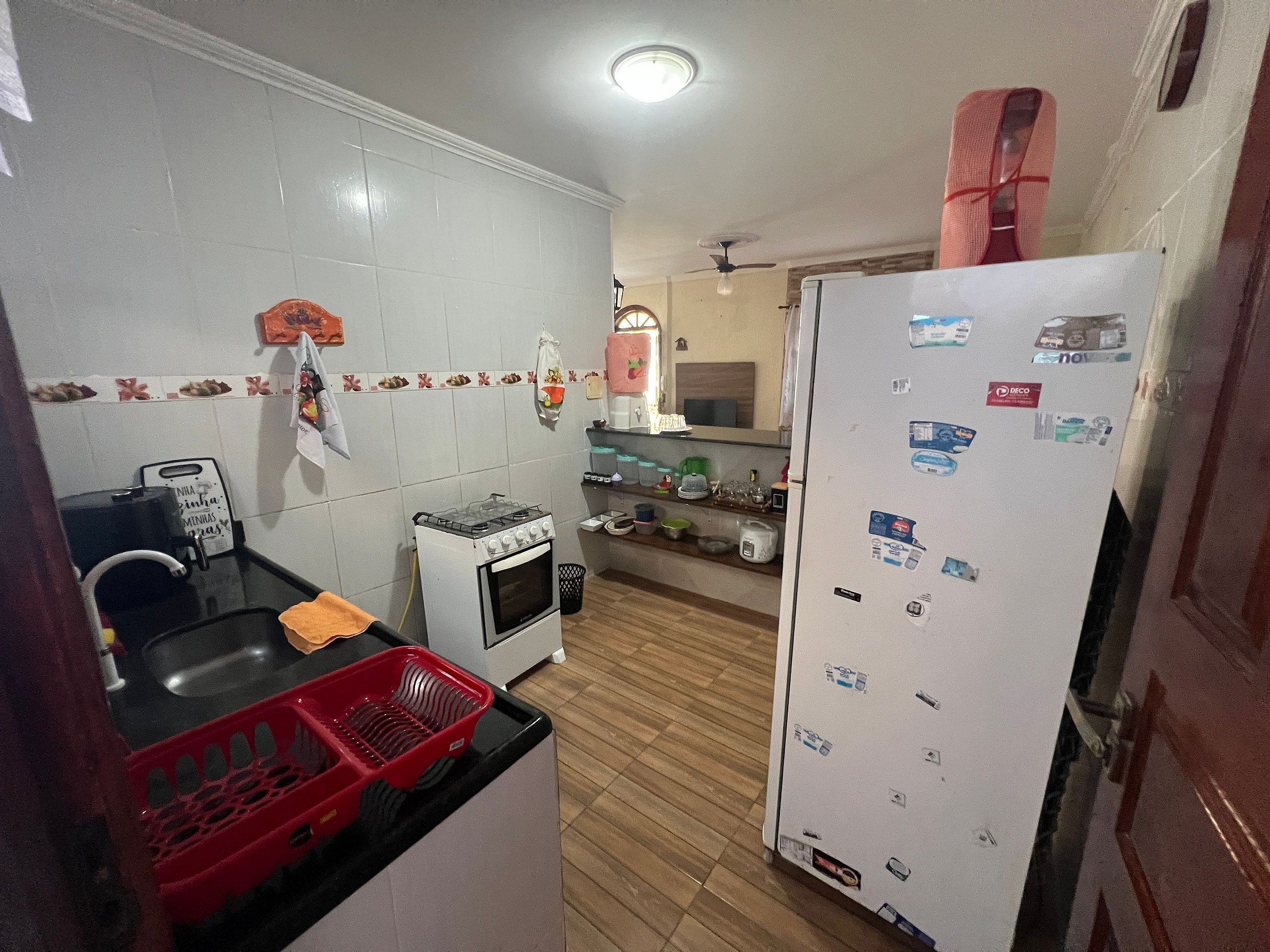 A compact kitchen with a gas stove, oven, and a refrigerator.