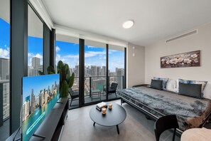 A modern hotel room with a large window, a bed, a coffee table, and a view of the cityscape. - We Host at 501 Residences - Miami Experience (Miami)