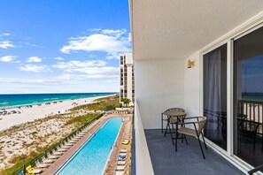 A balcony with a view of a beach and a pool. - Fully Renovated Beachfront Condo-Tiki Bar-3 Pools (Destin)