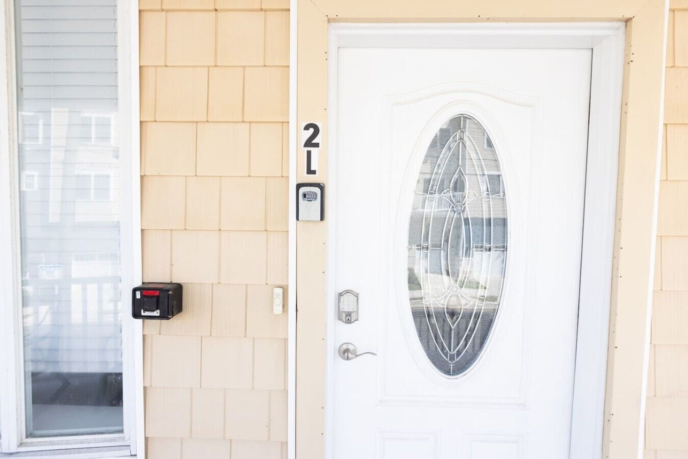 A white door with a glass panel and a number '2L' above it.
