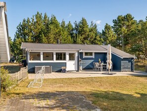 A single-story house with a front porch, a small deck, and a garage. - "Into" - 490m from the sea by Interhome (Sæby)
