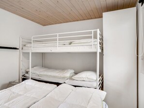 A bunk bed room with white bedding and a wooden ceiling. - "Melisande" -  from the sea by Interhome (Storvorde)