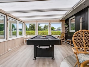 A pool table in a room with large windows, wooden flooring, and a view of greenery outside. - "Melisande" -  from the sea by Interhome (Storvorde)