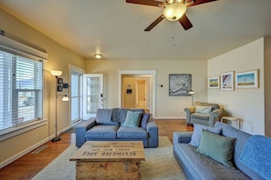 A living room with a ceiling fan, two sofas, a coffee table, and a door leading to another room. - Basecamp for your Buena Vista Adventures! STR-022 (Buena Vista)