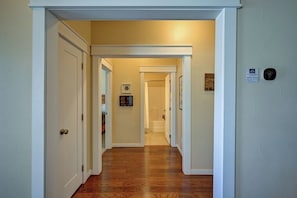 A hallway with wooden flooring, white walls, and a door at the end. - Basecamp for your Buena Vista Adventures! STR-022 (Buena Vista)