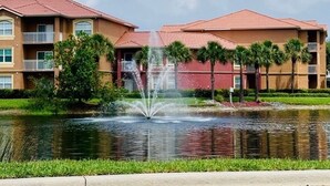 A hotel with a fountain, a pool, and a clear blue sky. - Peaceful Beachwalk Escape! Updated 3rd-Floor Condo w/ Lanai, Pool & Hot Tub (Fort Myers)